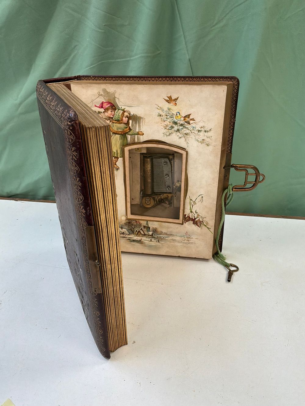 Lot 47: A Victorian style Gilt Tooled Leather Musical Photograph Album Titled The Seasons