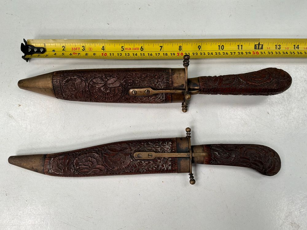 Lot 56: A Pair of Indian Style Hand Carved Wooden and Brass Meat Carving Tools with Matching Scabbards