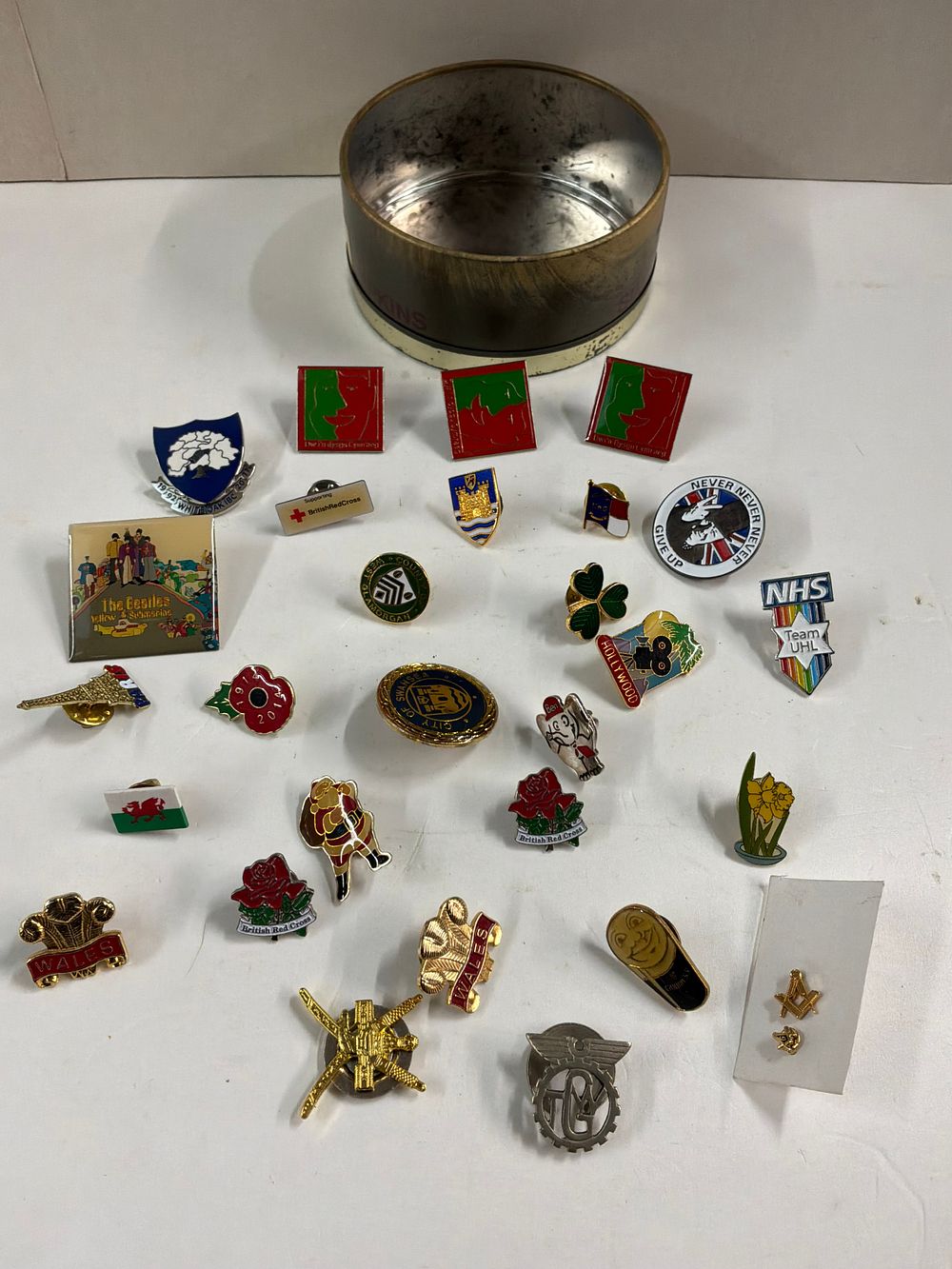 Lot 58: A Collection of Enamel and Metal Lapel Pins and Badges including The Beatles and NHS Examples
