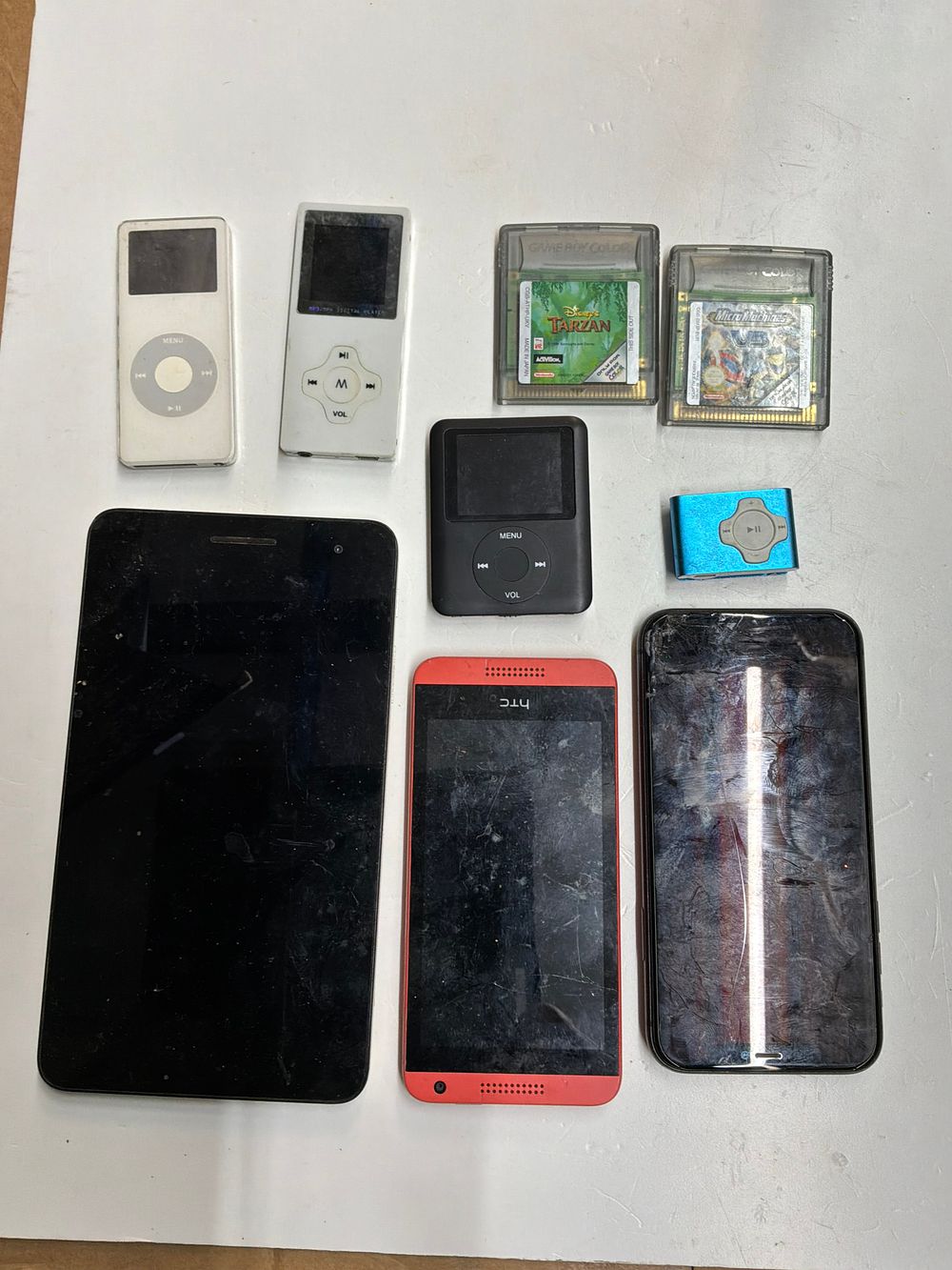 Lot 99: A Collection of Smartphones and Tablets including iPhone 11 and HTC Examples