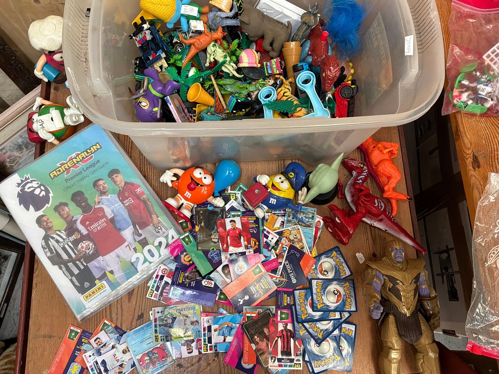Lot 108: A Collection of Assorted Modern Action Figures and Trading Cards Including Panini and Pokémon Examples