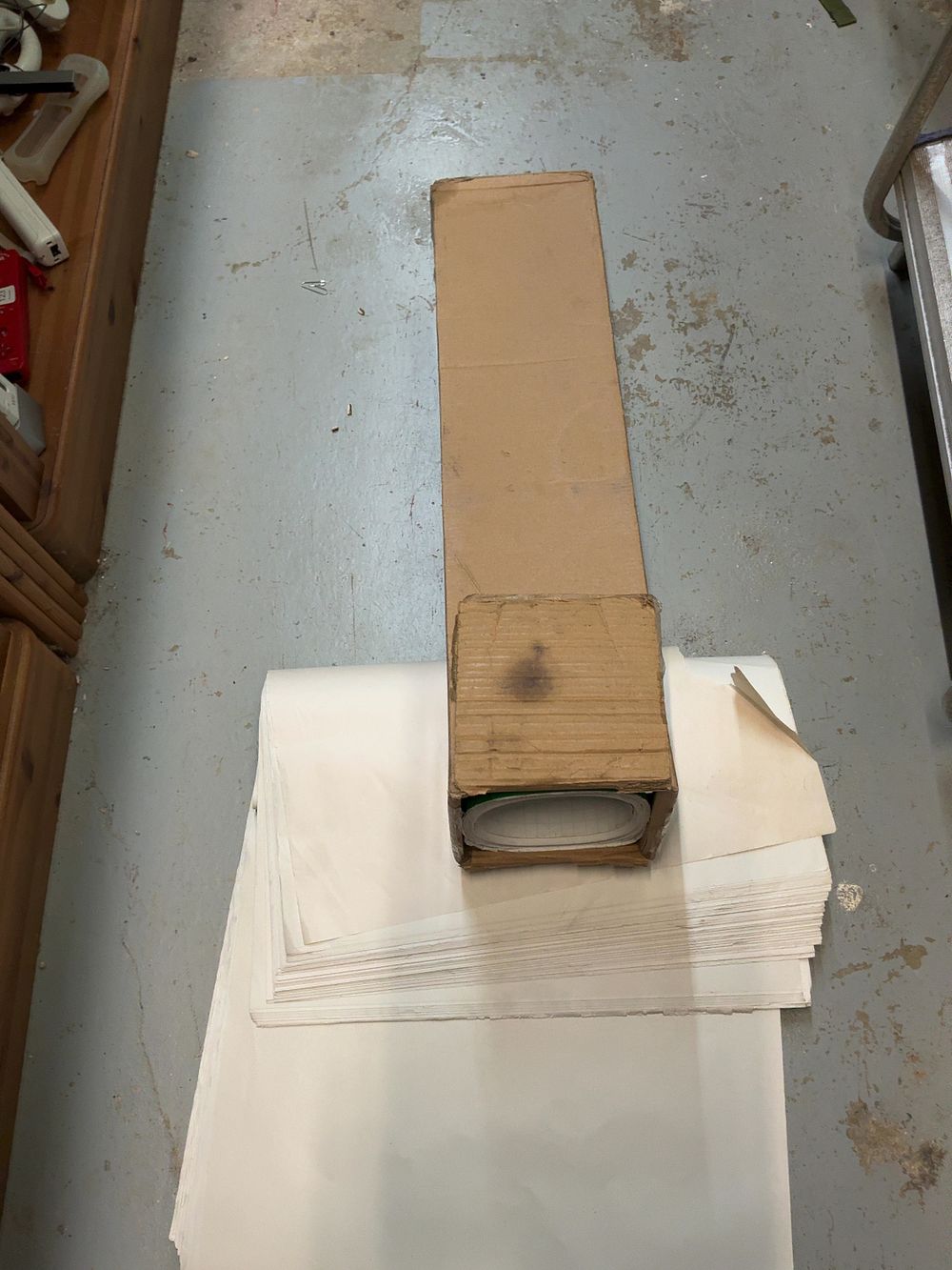 Lot 131: A Mixed Lot of Adhesive Green Vinyl Roll and a Quantity of White Paper Sheets