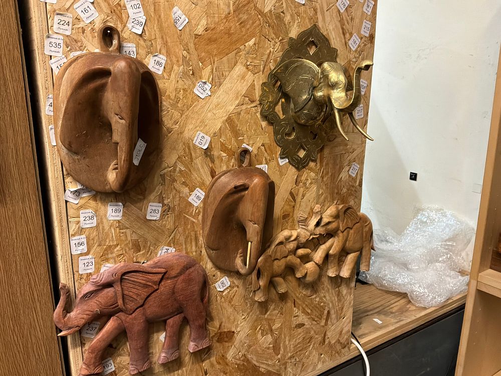 Lot 149: A Collection of Elephant Figurines and Wall Plaques in Carved Wood and Brass