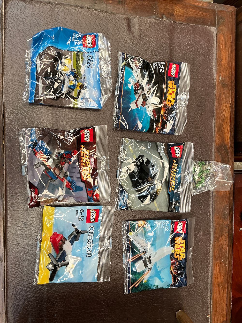 Lot 234: A Collection of Six Sealed LEGO Polybag Sets and Plastic Toy Figures