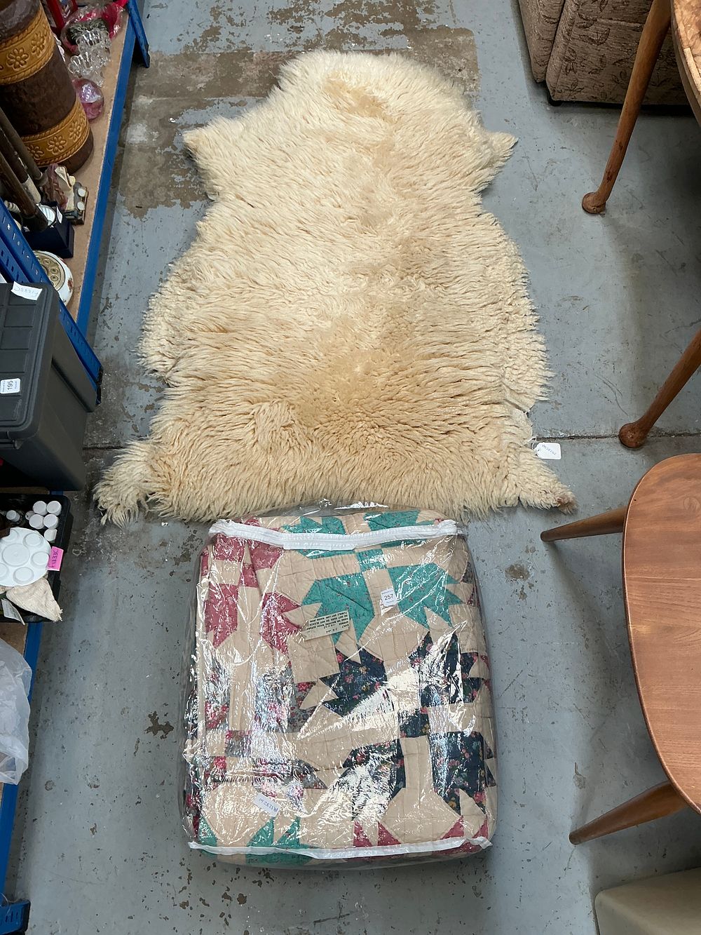 Lot 257: A Natural Single Pelt Sheepskin Rug and a Handmade Cotton Patchwork Quilt