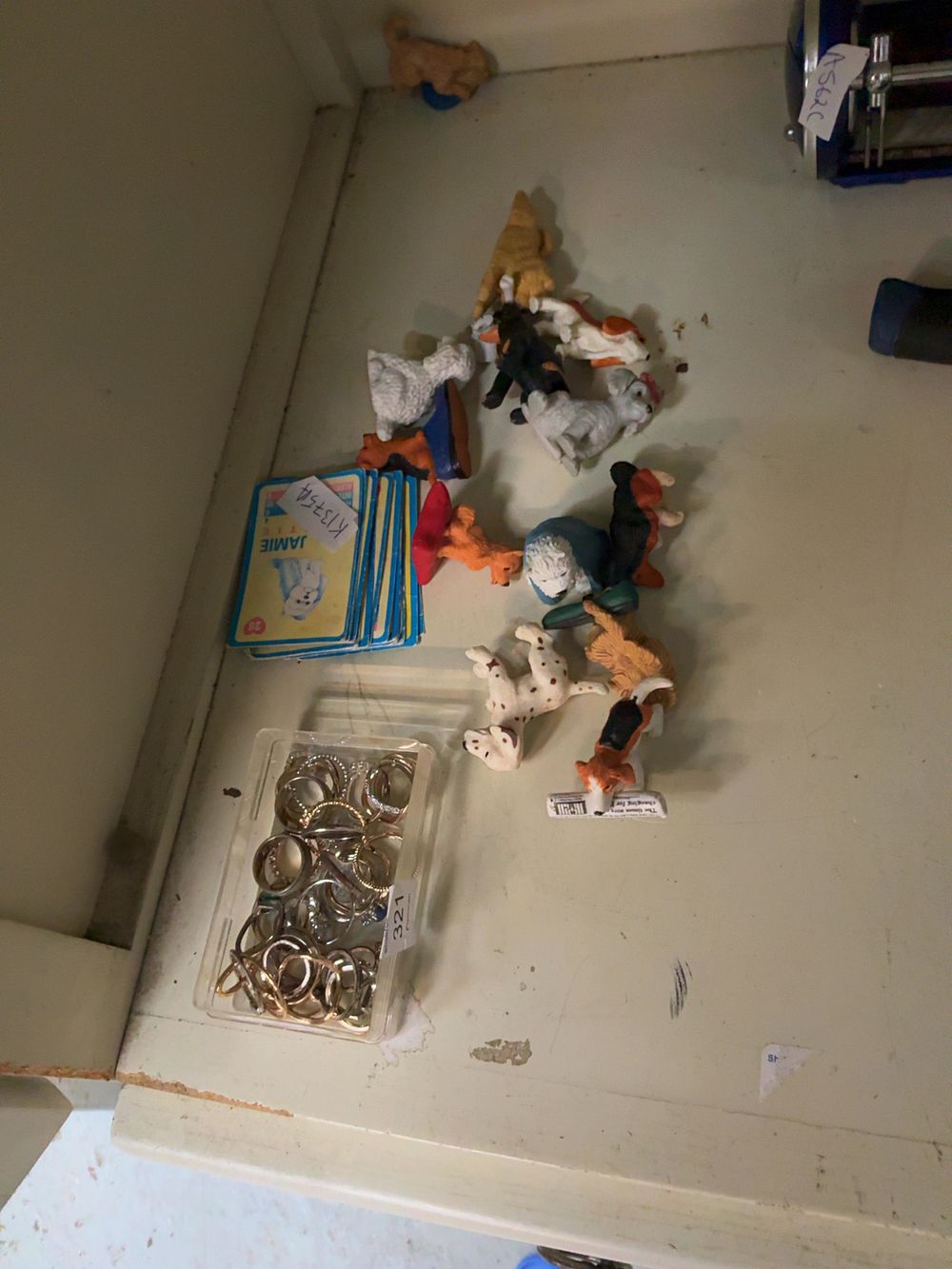 Lot 321: A Mixed Collection of Dog Figurines, Collector Cards, and Assorted Metal Rings