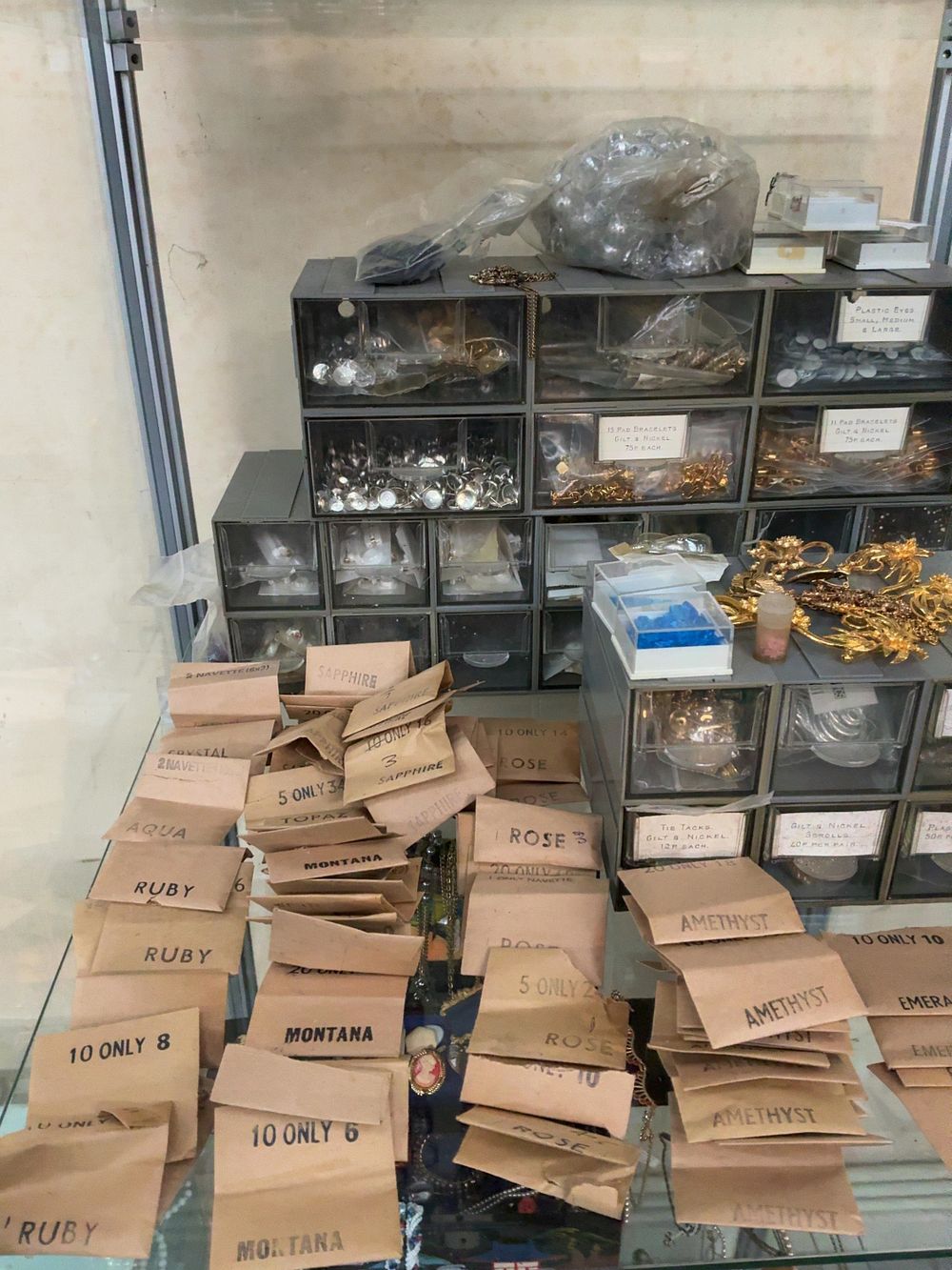Lot 365: A Collection of Vintage Costume Jewellery Components and Findings in Storage Units