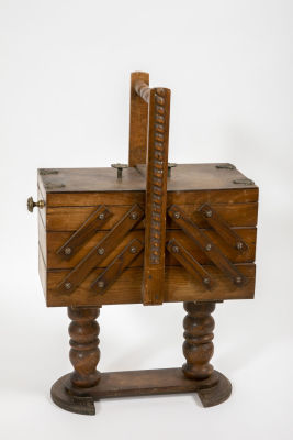 קופסת תפירה על רגליים. קופסת תפירה שהיא רהיט שלם, 
עם ידית נשיאה, נפתחת לשלוש קומות, 
עשויה עץ 