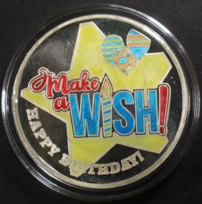 ONE OZ .999 ENAMELED MAKE A WISH SILVER ROUND. WEEKLY COIN & CURRENCY AUCTIONS ESTIMATE $75 - $100.