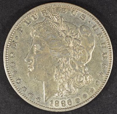 1886-O MORGAN DOLLAR XF/AU. CHECK OUT OUR UPCOMING AUCTIONS ESTIMATE $130 - $150.