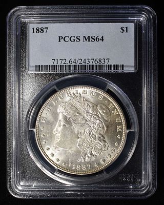 1887 MORGAN DOLLAR PCGS MS64. CHECK OUT OUR UPCOMING AUCTIONS ESTIMATE $100 - $150.