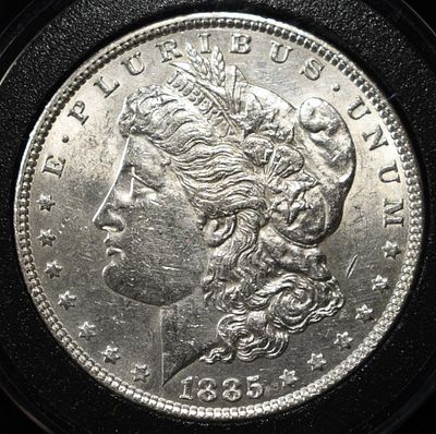 1885 MORGAN DOLLAR BU. CHECK OUT OUR UPCOMING AUCTIONS ESTIMATE $75 - $100.