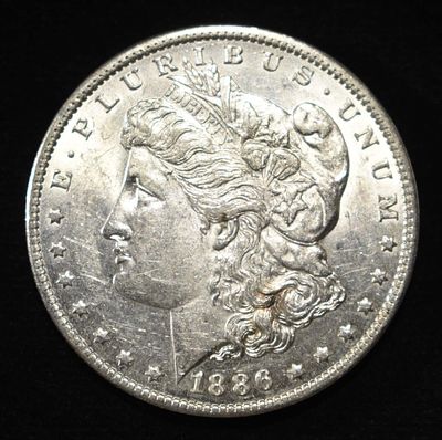 1886-O MORGAN DOLLAR BU RIM BUMP. CHECK OUT OUR UPCOMING AUCTIONS ESTIMATE $900 - $1000.