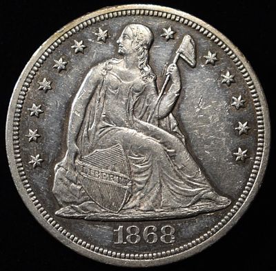 1868 SEATED LIBERTY DOLLAR AU/BU GREAT LUSTER. CHECK OUT OUR UPCOMING AUCTIONS ESTIMATE $3000 - 