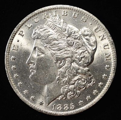 1885-O MORGAN DOLLAR BU. CHECK OUT OUR UPCOMING AUCTIONS ESTIMATE $75 - $100.