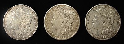 1921 P,D,S MORGAN DOLLARS. BID WITH SILVER CITY AUCTIONS ESTIMATE $180 - $220.