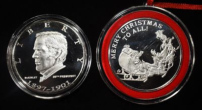 (2) 1 OZ SILVER ROUNDS. MERRY CHRISTMAS & MCKINLEY LEADERS IN ON-LINE AUCTIONS ESTIMATE $150 - $200.