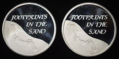 (2) 1 OZ FOOT PRINTS .999 SILVER ROUNDS. WEEKLY COIN & CURRENCY AUCTIONS ESTIMATE $120 - $160.
