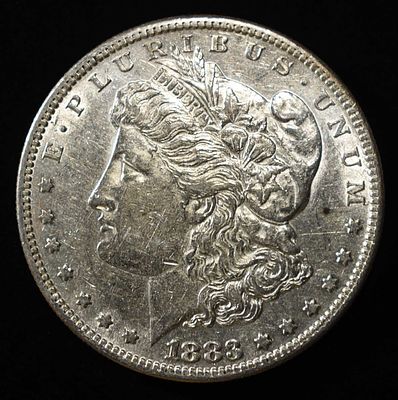 1883-S MORGAN DOLLAR AU. CHECK OUT OUR UPCOMING AUCTIONS ESTIMATE $200 - $250.