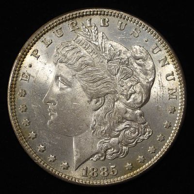 1885 MORGAN DOLLAR BU. CHECK OUT OUR UPCOMING AUCTIONS ESTIMATE $130 - $150.