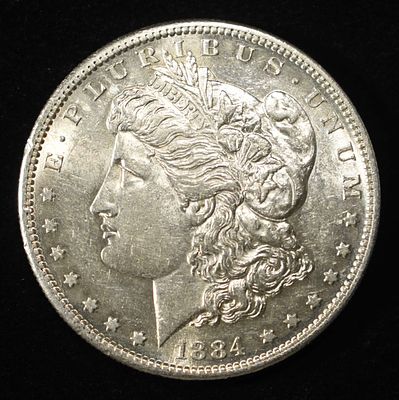 1884-S MORGAN DOLLAR AU/BU. CHECK OUT OUR UPCOMING AUCTIONS ESTIMATE $3000 - $3500.