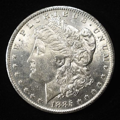 1885-O MORGAN DOLLAR BU. CHECK OUT OUR UPCOMING AUCTIONS ESTIMATE $100 - $130.