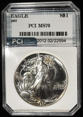 1987 AMERICAN SILVER EAGLE PCI PERFECT GEM BU. CHECK OUT OUR UPCOMING AUCTIONS ESTIMATE $130 - $180.