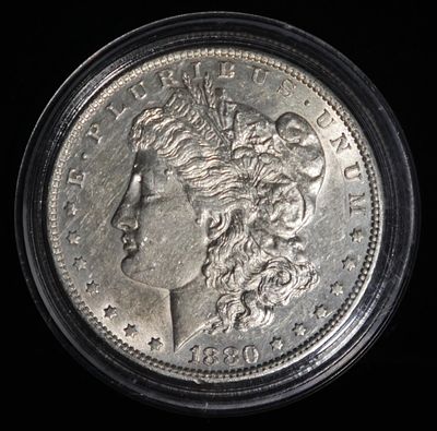 1880-O MORGAN DOLLAR AU. CHECK OUT OUR UPCOMING AUCTIONS ESTIMATE $75 - $100.