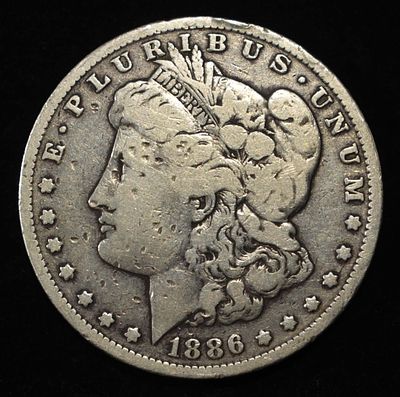1886-O MORGAN DOLLAR. CHECK OUT OUR UPCOMING AUCTIONS ESTIMATE $90 - $130.