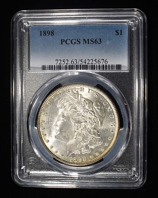 1898 MORGAN DOLLAR PCGS MS63. BID WITH SILVER CITY AUCTIONS ESTIMATE $160 - $210.