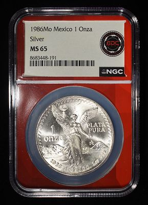1986 MEXICO 1 OZ 0.999 SILVER ROUND NGC MS65. BID WITH SILVER CITY AUCTIONS ESTIMATE $120 - $170.