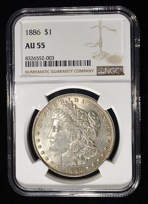 1886 MORGAN DOLLAR NGC AU55. BID WITH SILVER CITY AUCTIONS ESTIMATE $90 - $130.