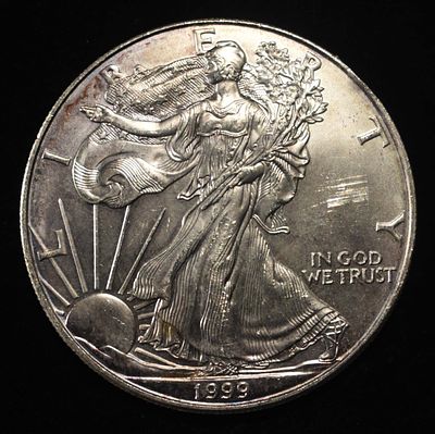 1999 AMERICAN SILVER EAGLE. BID WITH SILVER CITY AUCTIONS ESTIMATE $130 - $180.
