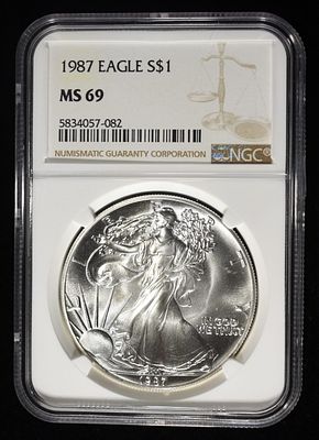 1987 AMERICAN SILVER EAGLE NGC MS69. BID WITH SILVER CITY AUCTIONS ESTIMATE $100 - $150.