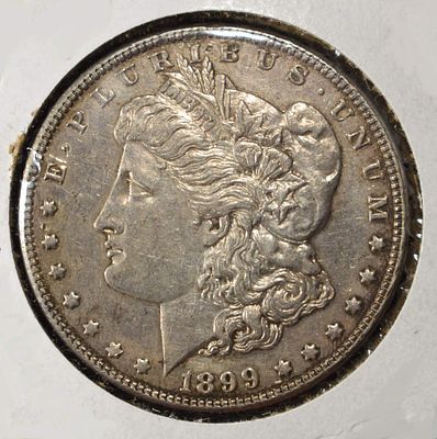 1899-P MORGAN DOLLAR AU CLEANED. TOP RATED AUCTION HOUSE ESTIMATE $160 - $210.