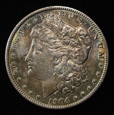 1904 MORGAN DOLLAR BU COLOR. CHECK OUT OUR UPCOMING AUCTIONS ESTIMATE $200 - $250.