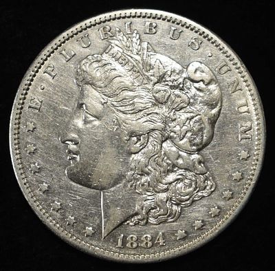 1884-S MORGAN DOLLAR AU. CHECK OUT OUR UPCOMING AUCTIONS ESTIMATE $300 - $350.