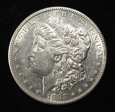 1885-S MORGAN DOLLAR AU. BID WITH SILVER CITY AUCTIONS ESTIMATE $200 - $250.