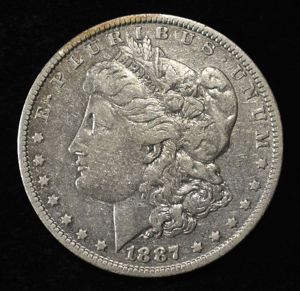 1887-O MORGAN DOLLAR. TOP RATED AUCTION HOUSE ESTIMATE $90 - $130.