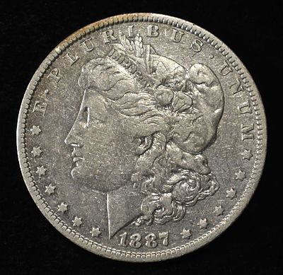 1887-O MORGAN DOLLAR. TOP RATED AUCTION HOUSE ESTIMATE $90 - $130.