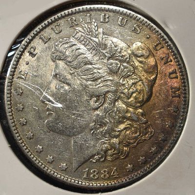 1884 MORGAN DOLLAR. CHECK OUT OUR UPCOMING AUCTIONS ESTIMATE $90 - $130.