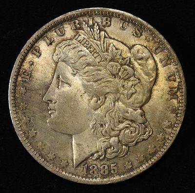 1885-O MORGAN DOLLAR. BID WITH SILVER CITY AUCTIONS ESTIMATE $90 - $130.