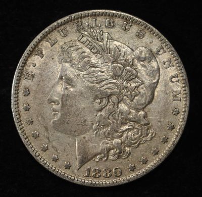 1880-O MORGAN DOLLAR XF/AU. CHECK OUT OUR UPCOMING AUCTIONS ESTIMATE $100 - $130.