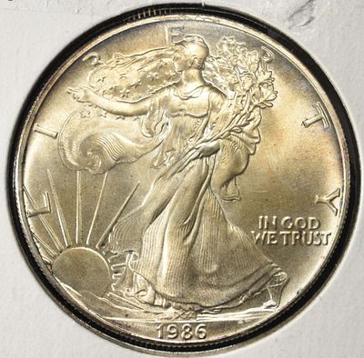 1986 AMERICAN SILVER EAGLE. BID WITH SILVER CITY AUCTIONS ESTIMATE $110 - $160.