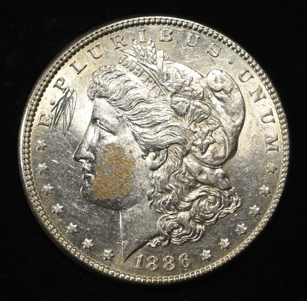 1886 MORGAN DOLLAR AU/BU. WEEKLY COIN & CURRENCY AUCTIONS ESTIMATE $100 - $130.