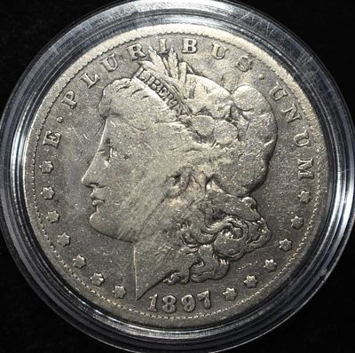 1897-O MORGAN DOLLAR. TOP RATED AUCTION HOUSE ESTIMATE $100 - $150.