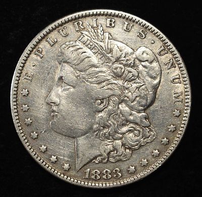 1883 MORGAN DOLLAR. BID WITH SILVER CITY AUCTIONS ESTIMATE $90 - $130.