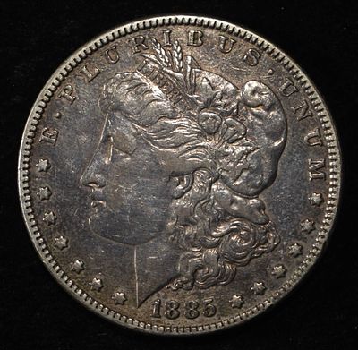 1885 MORGAN DOLLAR. TOP RATED AUCTION HOUSE ESTIMATE $90 - $130.