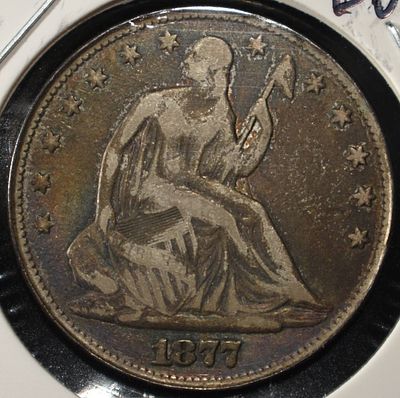 1877 SEATED LIBERTY HALF DOLLAR. TOP RATED AUCTION HOUSE ESTIMATE $110 - $160.