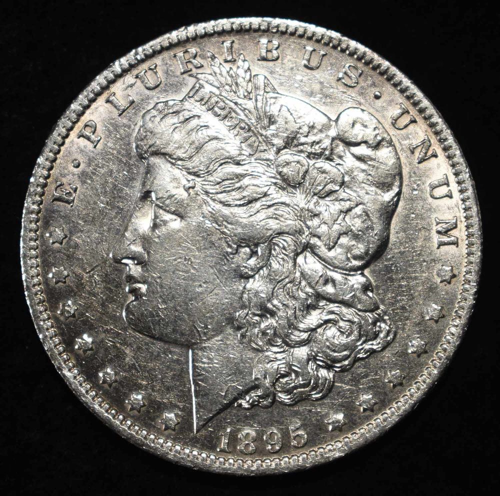 1895-O MORGAN DOLLAR AU. CHECK OUT OUR UPCOMING AUCTIONS ESTIMATE $2050 - $2150.